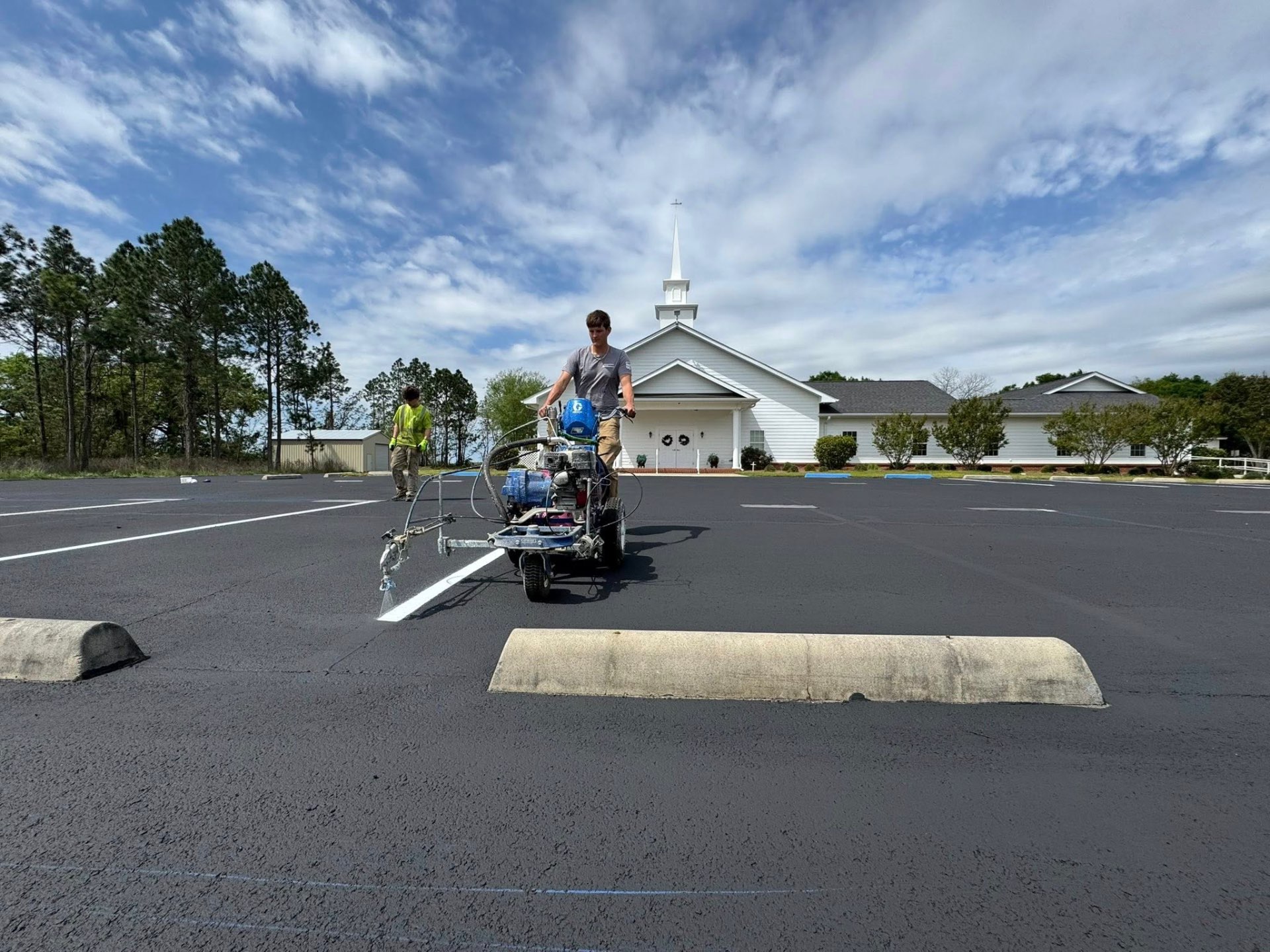 Line striping a freshly sealed church parking lot