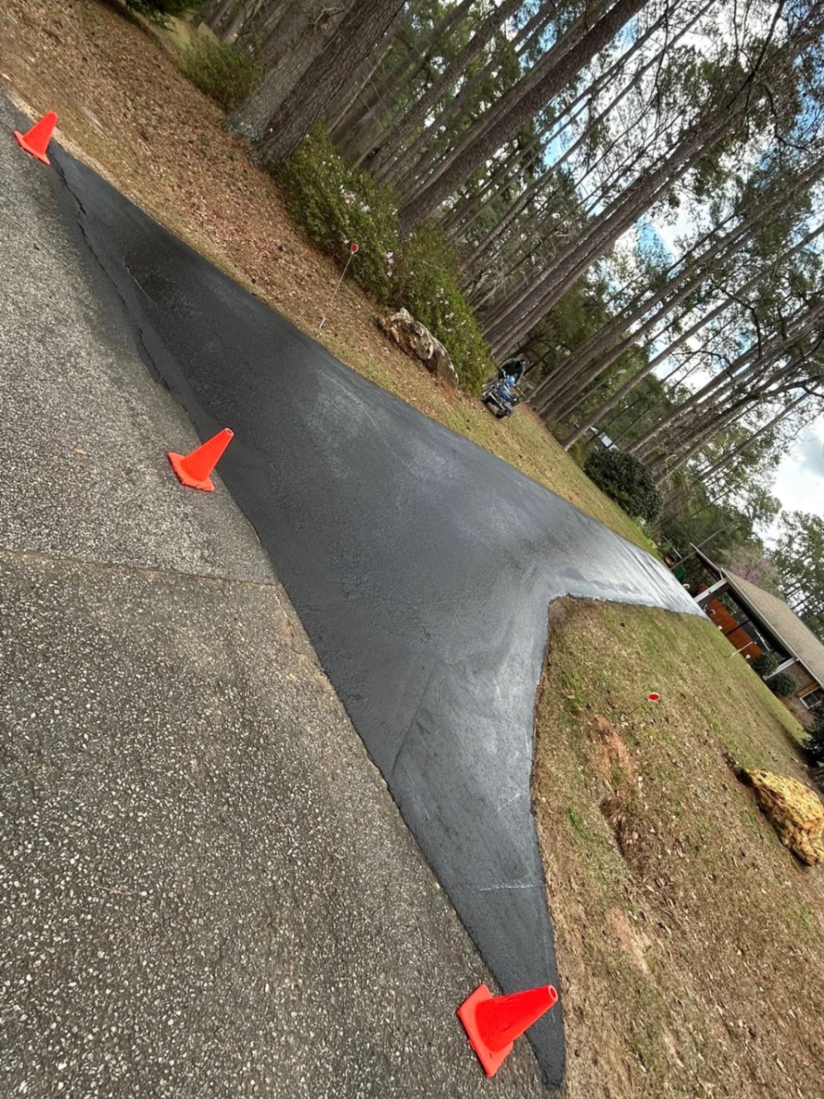 Long curved residential driveway after seal coating