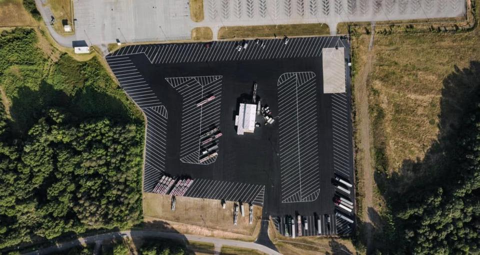 Aerial view of a large freshly sealed and striped commercial lot