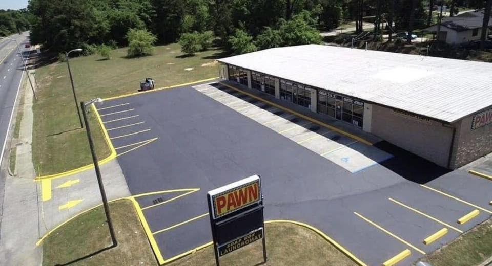 Retail parking lot with yellow striping and accessibility markings